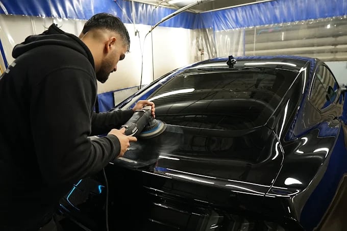 Machine polishing a car's paintwork in the Premium Autopesu workshop